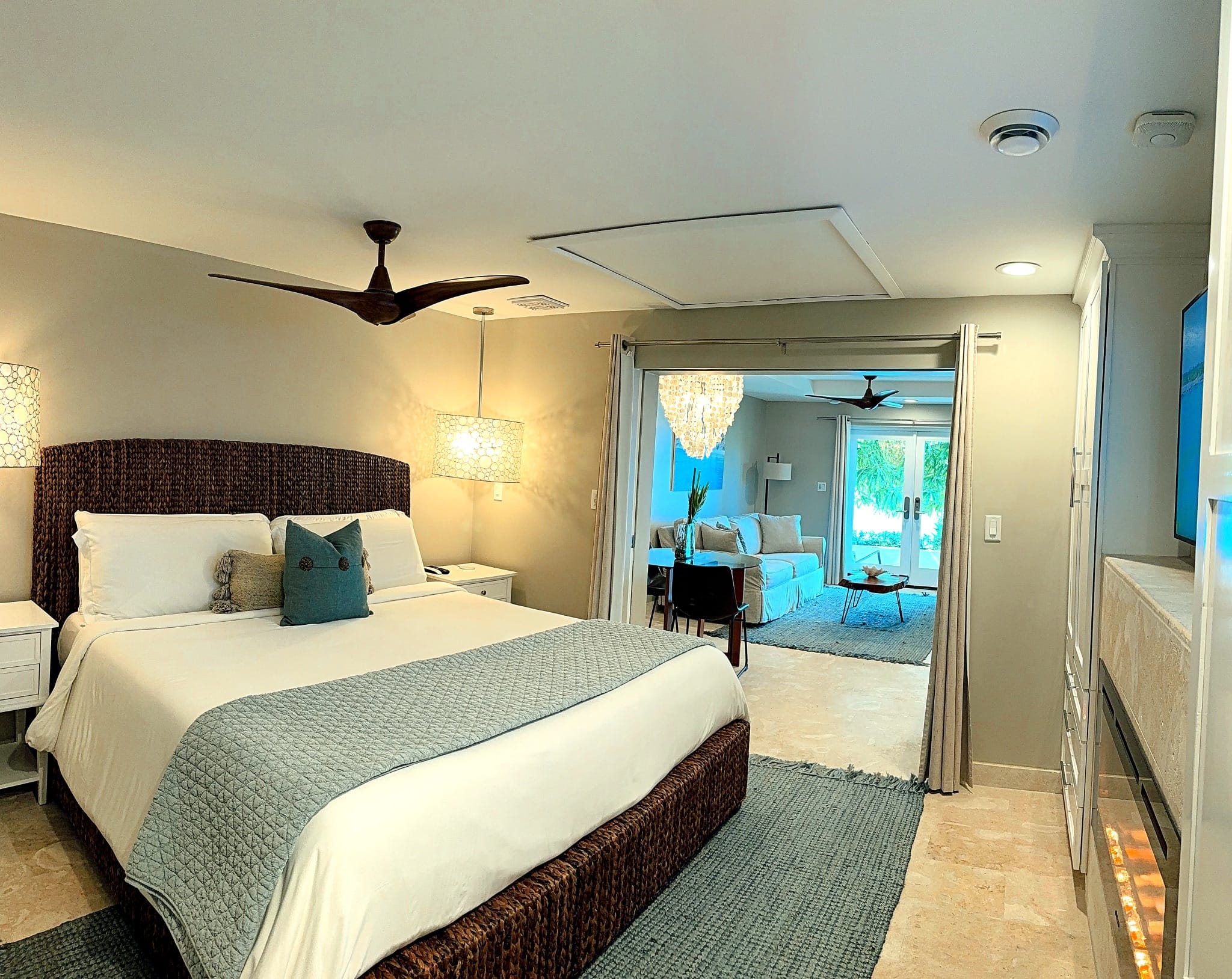 Bedroom and living area of the Poinciana Standard King Suite
