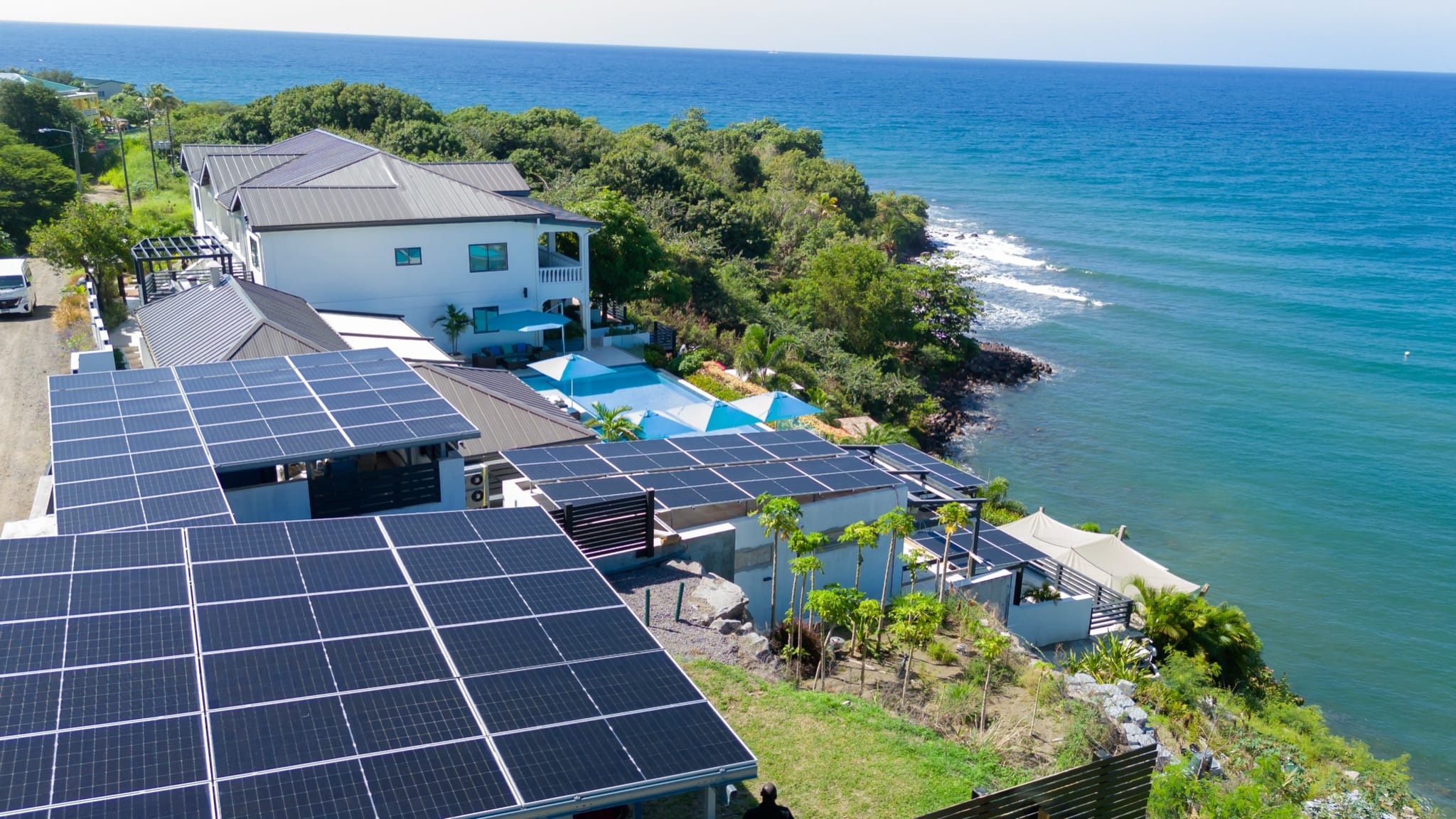 Aerial view of Sunset Reef's solar panels beside the resort buildings